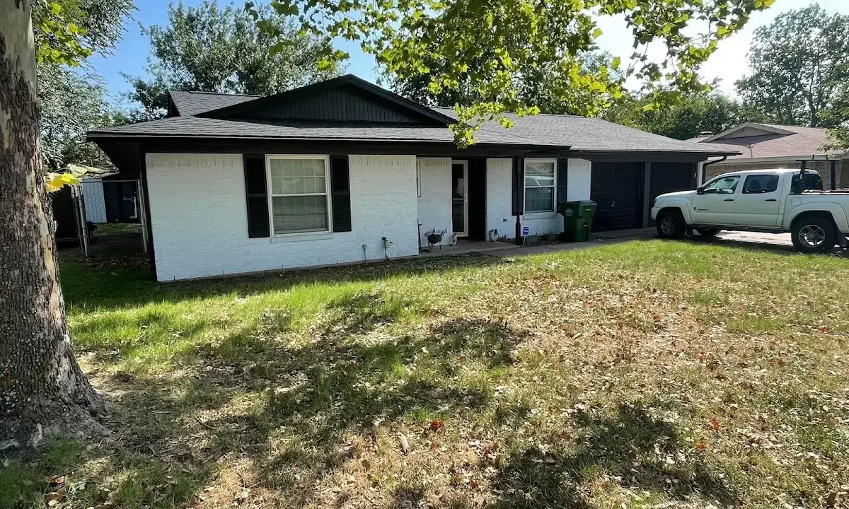 Professional roofing crew working on a residential roof in Archdale